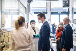 The politicians pay the scientists a visit in their laboratories.